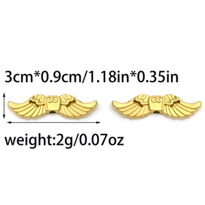 Macro view of matte gold 304 stainless steel angel wing charms with 3x0.9cm dimensions