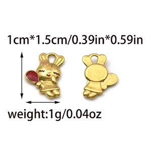 Front and back detail of a golden rabbit pendant with pink ears and dimensions