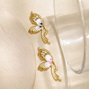 Detailed close-up of 304 stainless steel butterfly pendants with white enamel wings