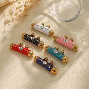 Detail of 304 stainless steel evil eye tube pendants in six enamel colors with gold end caps