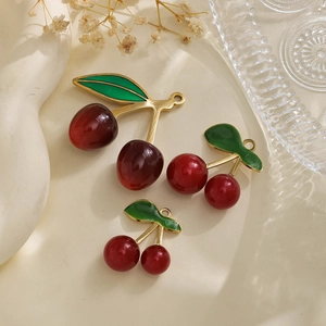 Detailed macro of 304 stainless steel cherry pendants in three sizes for DIY jewelry