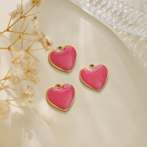 Three gold-plated heart-shaped enamel charms with pink filling for jewelry making