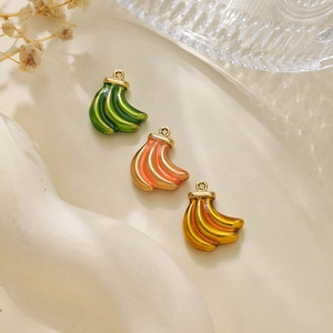 Detailed close-up of colorful enamel banana pendants with gold rings for DIY jewelry