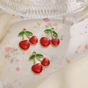 Macro detail of three cherry enamel charms made of 304 stainless steel for DIY jewelry