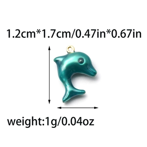 Detail view of teal dolphin pendant with dimensions 1.2cm x 1.7cm and golden ring