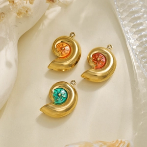Detail of colorful enamel shell pendants in gold stainless steel with hanging hooks