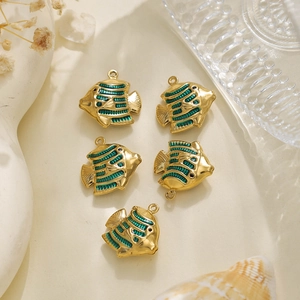 Detailed macro view of five golden tropical fish charms with emerald green enamel finish