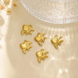 Detailed close-up of five matte gold tropical fish charms for DIY jewelry making