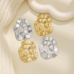 Close-up of hammered 304 stainless steel swirl pendants in gold and silver finish