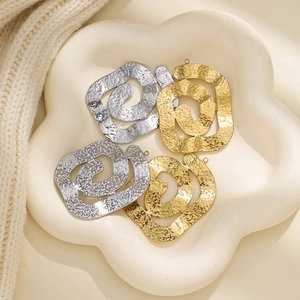 Macro detail of irregular spiral 304 stainless steel pendants with hammered texture finish