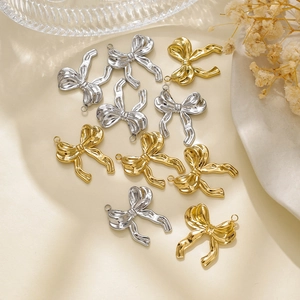 Macro shot of 304 stainless steel bow charms with textured gold and silver finishes