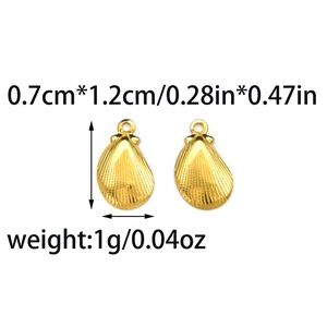 Macro view of gold shell-shaped stainless steel earrings with fine vertical stripes