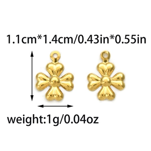 Detail view of gold clover pendants with measurements of 1.1cm by 1.4cm for DIY jewelry