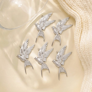 Detailed view of five 304 stainless steel swallow pendants with fine feather textures