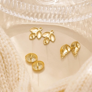 Detail of gold floral and leaf stainless steel earring studs with loop for DIY jewelry