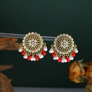 Detail of vintage mandala earrings with crystals and hanging red and white beads