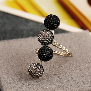 Minimalist gold rope ring with four black crystal studded spheres in an open design
