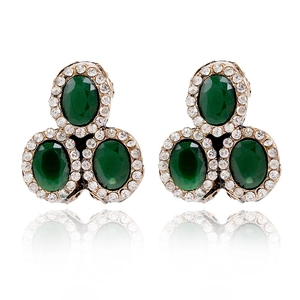 Macro view of vintage stud earrings with oval green gems and micro-pave crystals