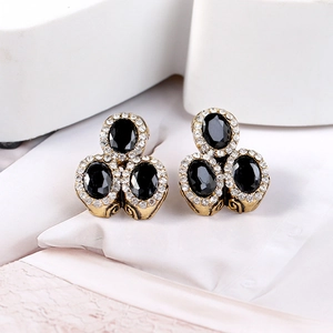 Macro shot of vintage style earrings with black stones and fine crystal pavé details