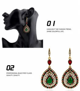 Detail view of bohemian waterdrop earrings with green stones and colorful rhinestones