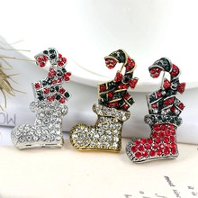 Macro detail of Christmas sock brooches with colorful rhinestones on vintage book pages