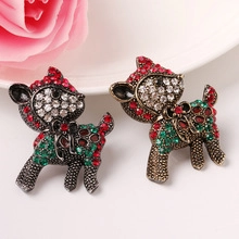 Detail of two reindeer brooches with red and green rhinestones for Christmas