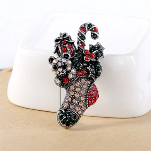 Detailed view of vintage silver Christmas stocking brooch with multicolored rhinestones