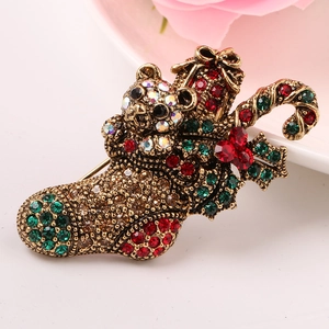 Macro detail of vintage Christmas stocking brooch with rhinestones and teddy bear