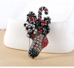 Detail of vintage Christmas stocking brooch with teddy bear and sparkling rhinestones