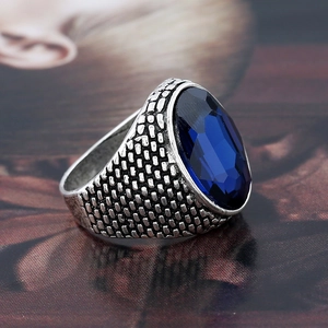 Vintage men's silver ring with large oval blue crystal and intricate textured band