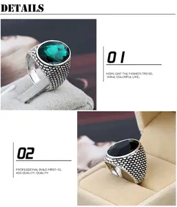 Detail of alloy rings featuring emerald green and black crystals with textured bands