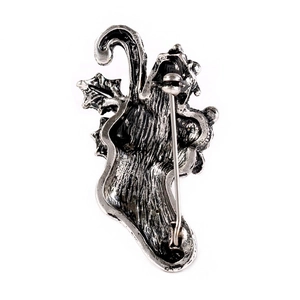 Back view of vintage silver Christmas stocking brooch with safety pin and metal texture