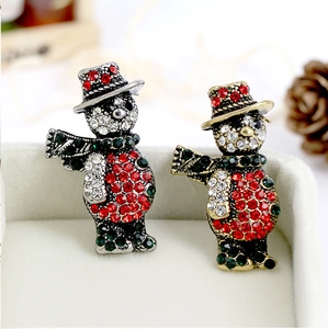 Détail macro de broches bonhomme de neige avec strass scintillants dans une boîte cadeau