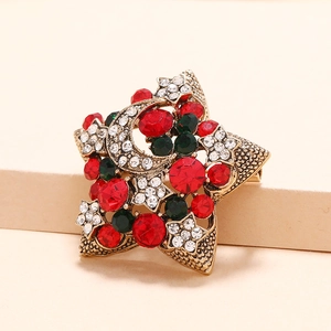 Broche de Noël étoile vintage avec cristaux rouges et verts sur croissant doré