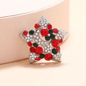 Broche de Noël vintage avec strass colorés et croissant de lune sur un présentoir