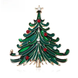 Detail of Christmas tree brooch with green enamel, red rhinestones and golden star