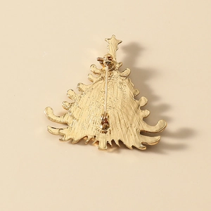 Back view of gold Christmas tree brooch showing the safety pin clasp and matte metal finish