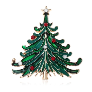 Golden Christmas tree brooch with green enamel and sparkling rhinestones on white base