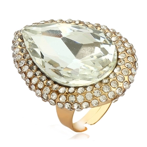 Macro detail of a gold teardrop ring with pear-cut crystal and micro-pave setting