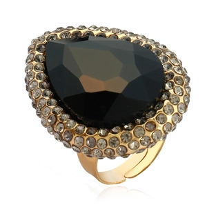 Macro detail of a cocktail ring featuring a black pear-cut gemstone with gold band