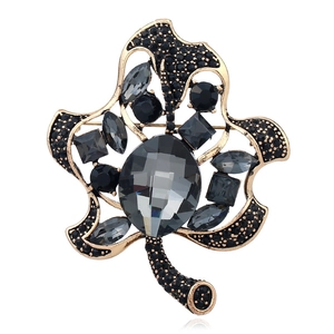 Vintage gold leaf brooch with deep grey crystals and black pavé rhinestones in maple design