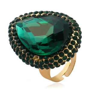 Detail of emerald green teardrop crystal ring with vintage gold adjustable band