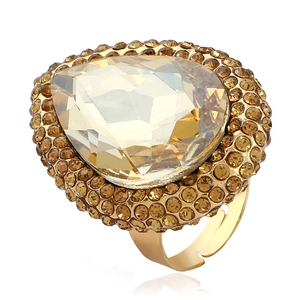 Detailed close-up of a large teardrop-shaped champagne crystal ring with gold open band