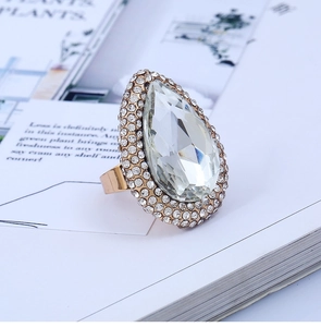 Detailed view of the large teardrop crystal and double halo pavé rhinestones on gold ring