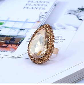 Detailed macro view of a vintage champagne pear cut crystal ring with gold plating