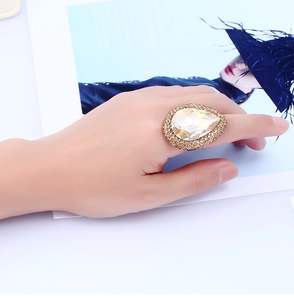 Detailed shot of oversized champagne pear-cut crystal ring with micro-pave setting