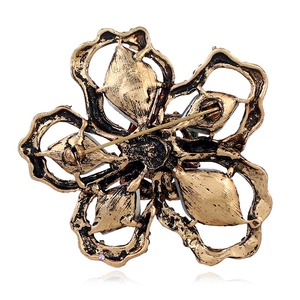 Vintage hollow flower brooch in antique gold finish with pin buckle back view