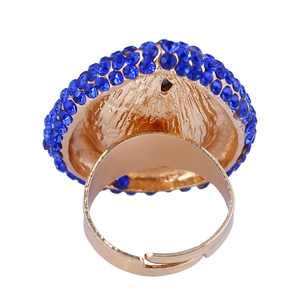 Adjustable golden cocktail ring featuring sparkling blue crystals and a flexible open band