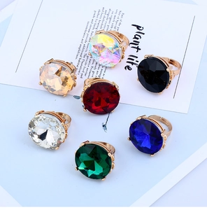 Macro shot of a 7-piece set of gold rings with colorful multifaceted crystal gemstones