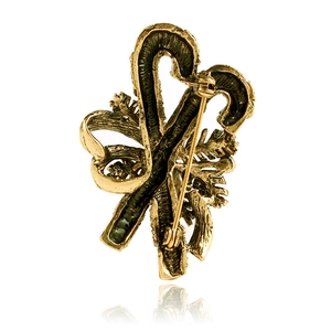 Detail view of the vintage gold candy cane brooch back with a secure safety pin clasp